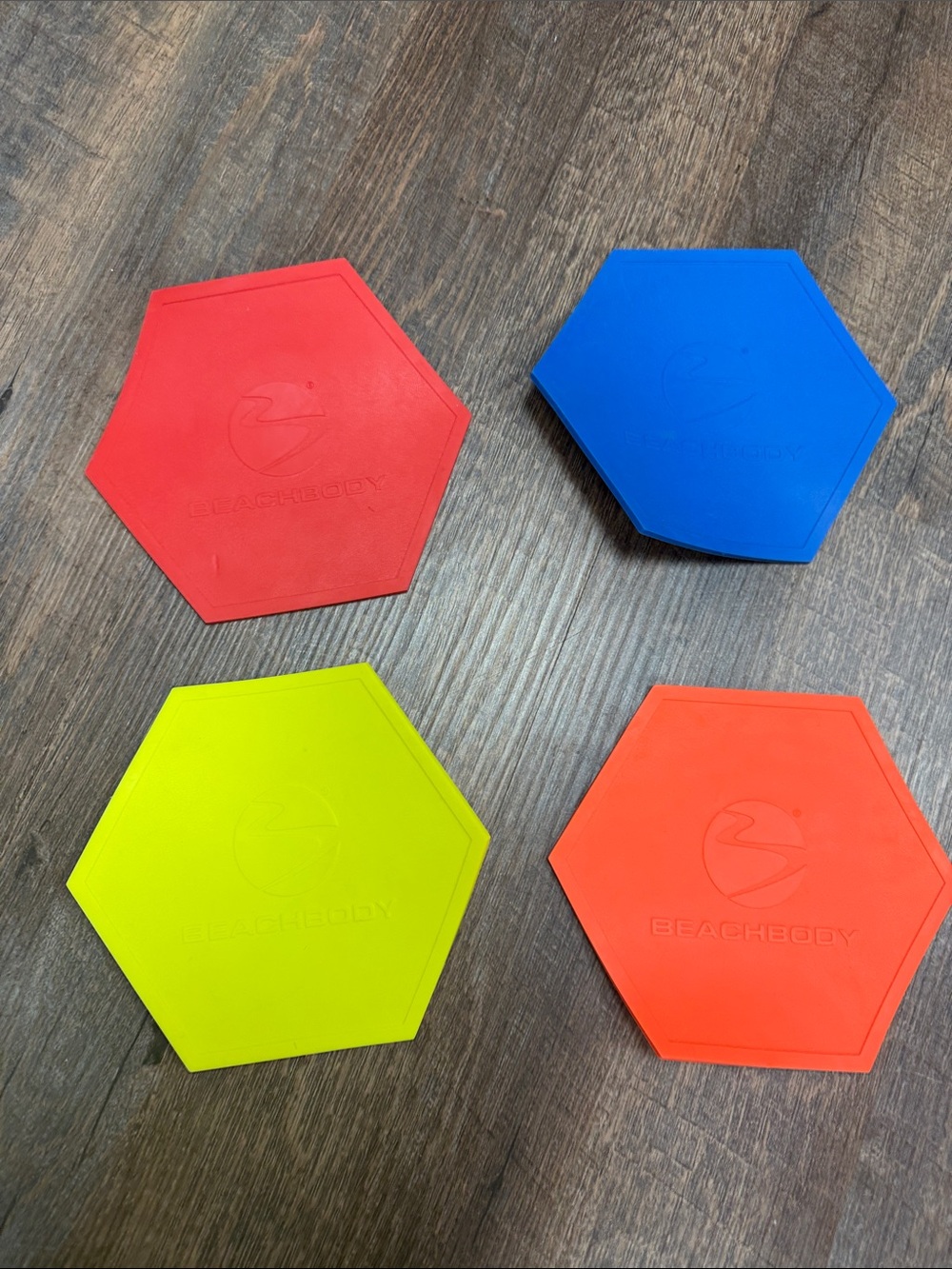 Beachbody Hexagon Sliding Discs in Red, Blue, Yellow, Orange